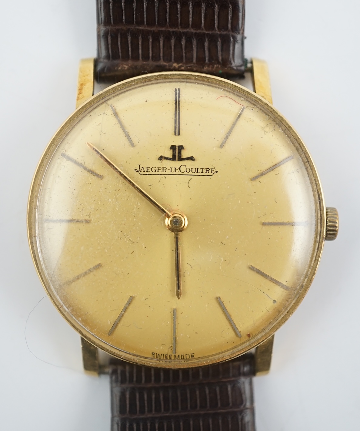 A gentleman's 18ct gold Jaeger LeCoultre manual wind dress wrist watch, on an associated strap
